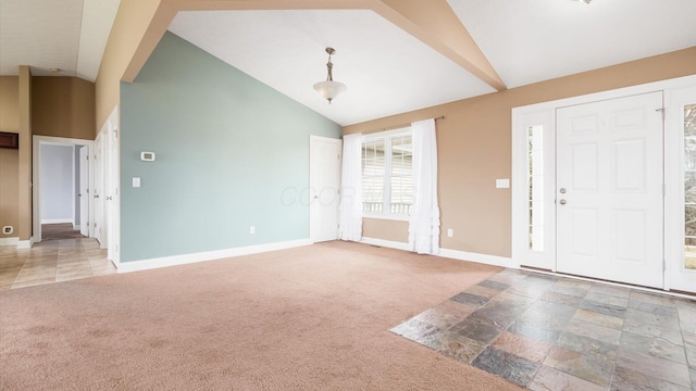 entrance foyer featuring carpet floors, high vaulted ceiling, and baseboards