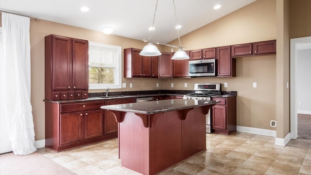 kitchen with a sink, a kitchen breakfast bar, appliances with stainless steel finishes, a center island, and lofted ceiling