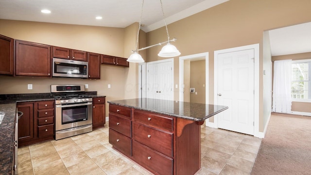 kitchen with high vaulted ceiling, appliances with stainless steel finishes, baseboards, decorative light fixtures, and dark stone counters