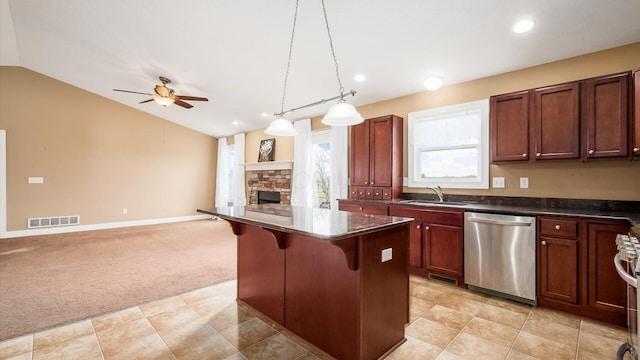 kitchen with a sink, a ceiling fan, light carpet, appliances with stainless steel finishes, and visible vents