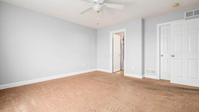 unfurnished bedroom featuring light carpet, baseboards, visible vents, and ceiling fan