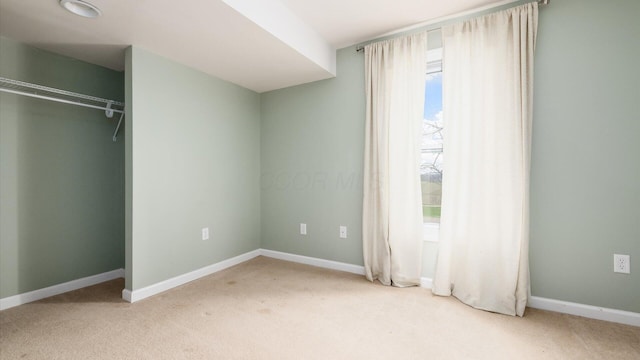 unfurnished bedroom featuring baseboards, a closet, and carpet flooring
