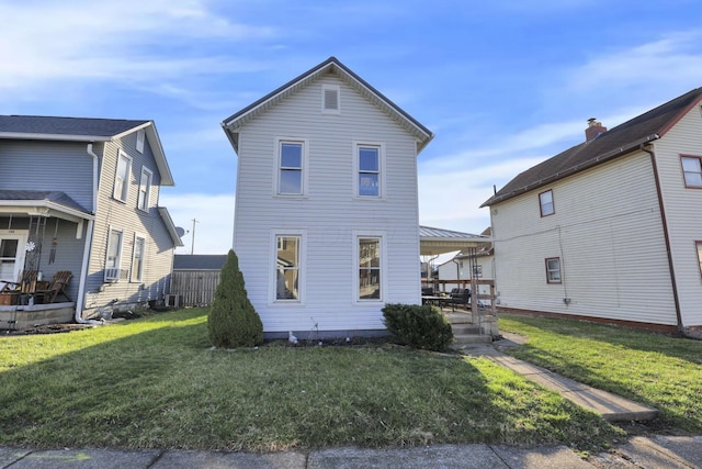 view of front facade with a front yard and a patio