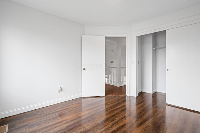 unfurnished bedroom with baseboards, visible vents, a closet, and wood finished floors