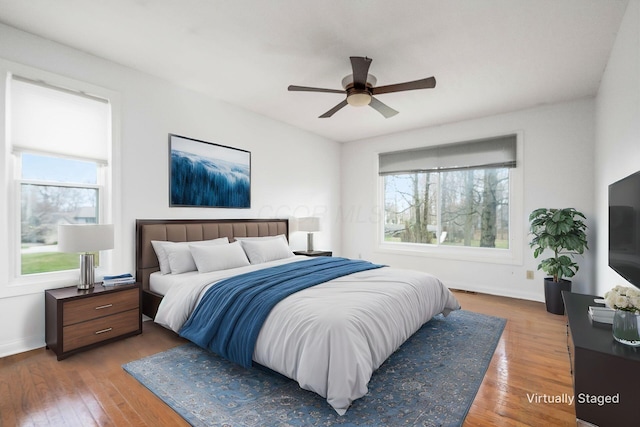 bedroom featuring hardwood / wood-style flooring, baseboards, and ceiling fan