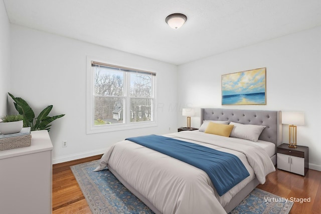 bedroom featuring baseboards and wood finished floors