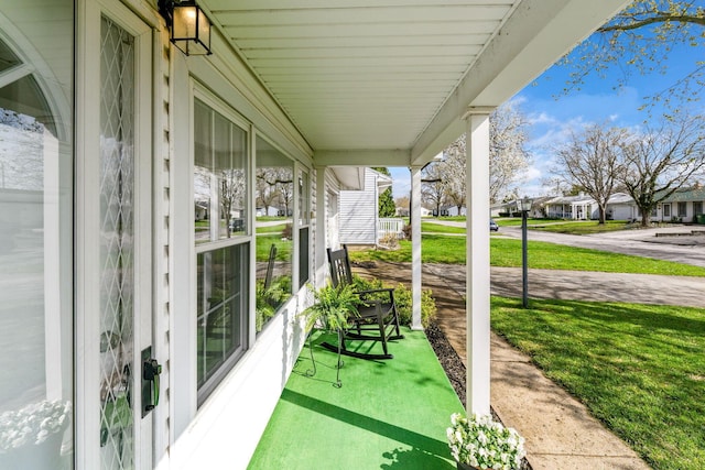 view of patio / terrace with a residential view and covered porch