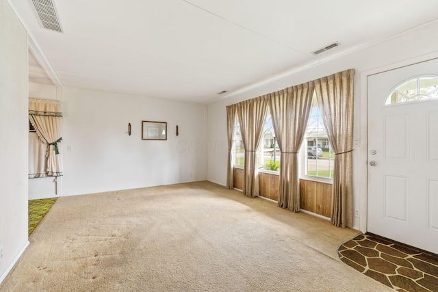 carpeted entryway featuring visible vents