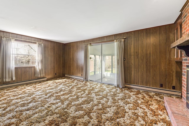 unfurnished living room with wooden walls, plenty of natural light, carpet, and baseboard heating