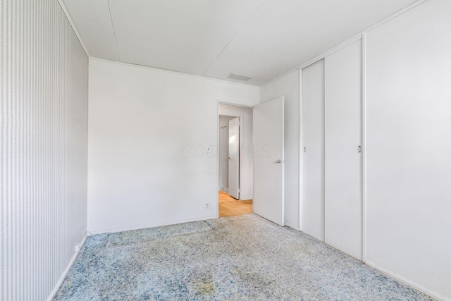 unfurnished bedroom with visible vents and baseboards