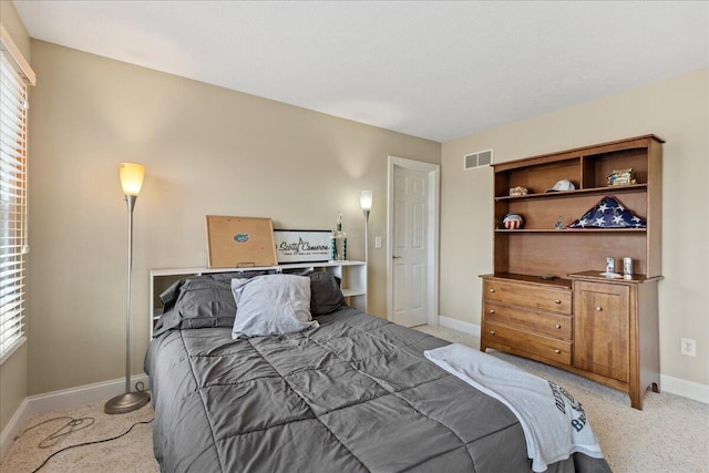 bedroom with visible vents, baseboards, and light colored carpet
