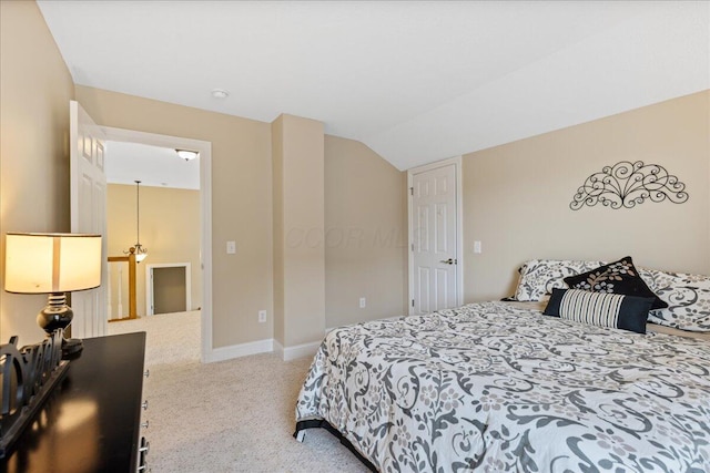 bedroom with baseboards, lofted ceiling, and carpet floors