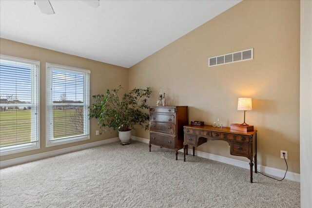 living area featuring carpet flooring, visible vents, baseboards, and vaulted ceiling