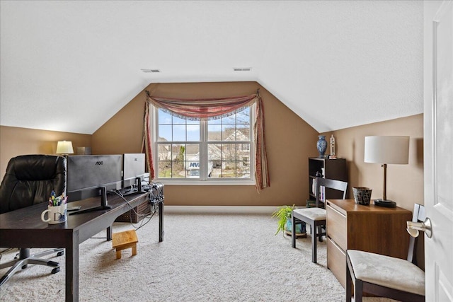 office with carpet flooring, visible vents, baseboards, and vaulted ceiling
