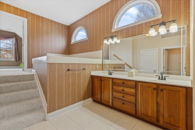 bathroom featuring a sink, tile patterned floors, a wealth of natural light, and wallpapered walls