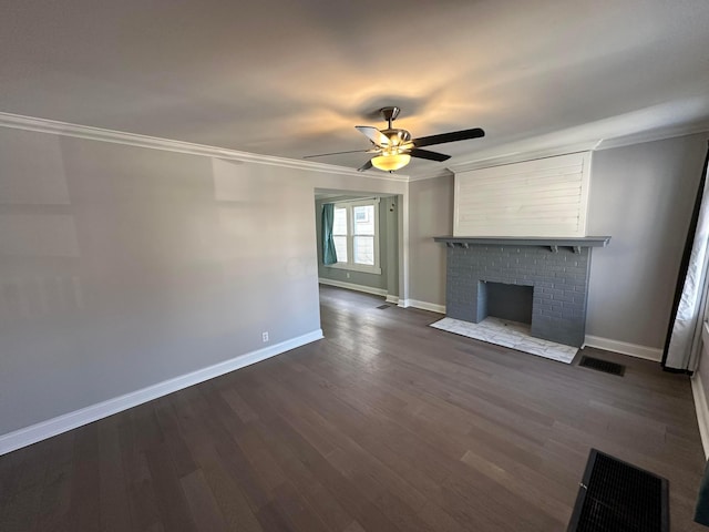unfurnished living room with crown molding, baseboards, a fireplace, a ceiling fan, and dark wood-style floors
