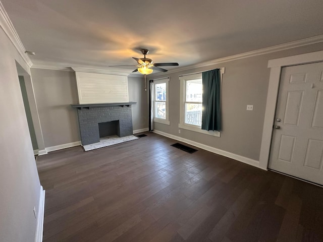 unfurnished living room featuring visible vents, crown molding, a fireplace, ceiling fan, and dark wood-style floors