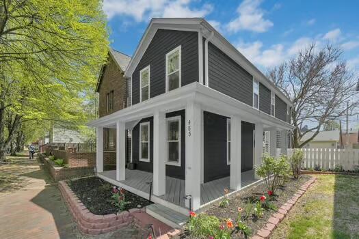 view of home's exterior with a sunroom and fence