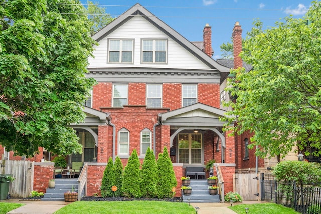 62 Sherman Ave, Columbus, OH 43205 - view of front of house featuring covered porch, brick siding, a gate, and a chimney