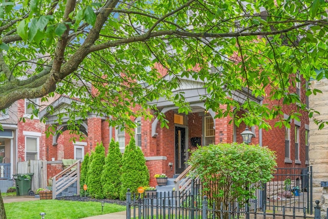 62 Sherman Ave, Columbus, OH 43205 - view of front facade with brick siding, a fenced front yard, and a gate