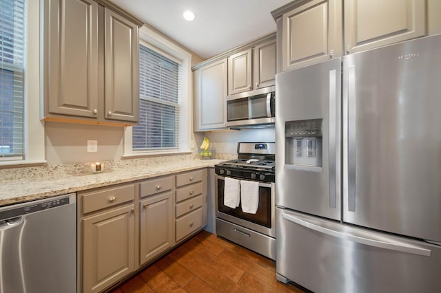 62 Sherman Ave, Columbus, OH 43205 - kitchen with appliances with stainless steel finishes, dark wood finished floors, light stone counters, recessed lighting, and gray cabinetry