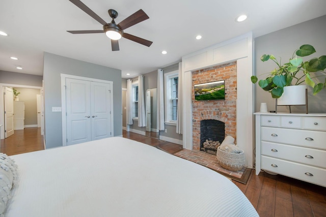 62 Sherman Ave, Columbus, OH 43205 - bedroom featuring dark wood-type flooring, a brick fireplace, recessed lighting, a closet, and baseboards