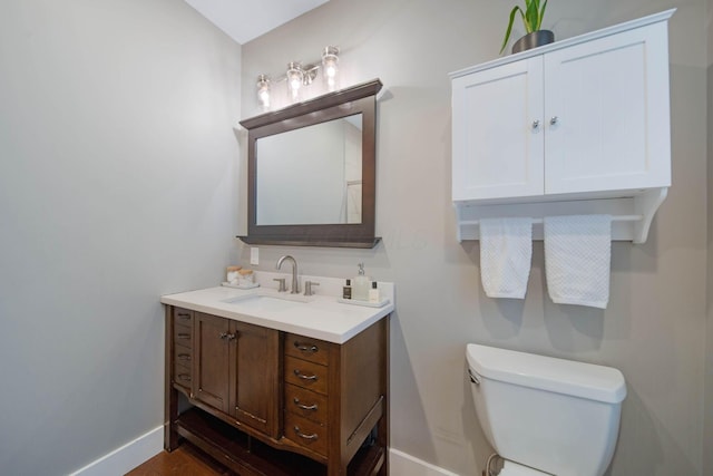 62 Sherman Ave, Columbus, OH 43205 - bathroom with baseboards, vanity, and toilet