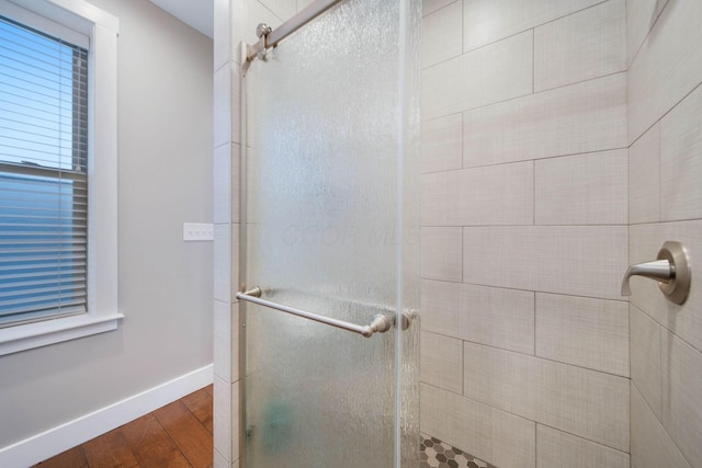 62 Sherman Ave, Columbus, OH 43205 - full bath featuring wood finished floors, a stall shower, and baseboards