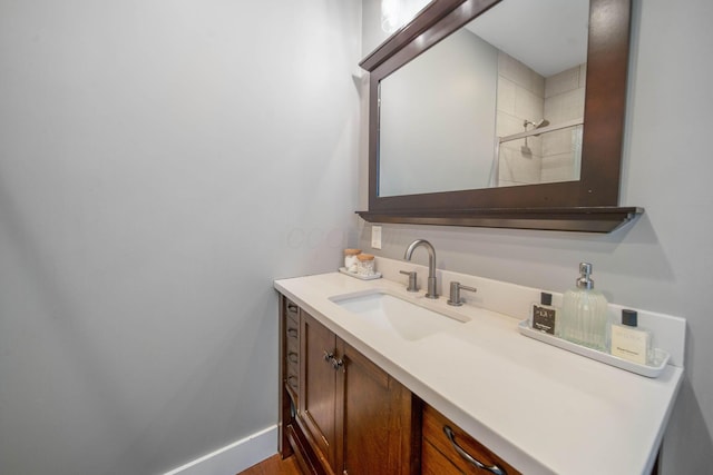 62 Sherman Ave, Columbus, OH 43205 - bathroom with vanity, tiled shower, baseboards, and wood finished floors