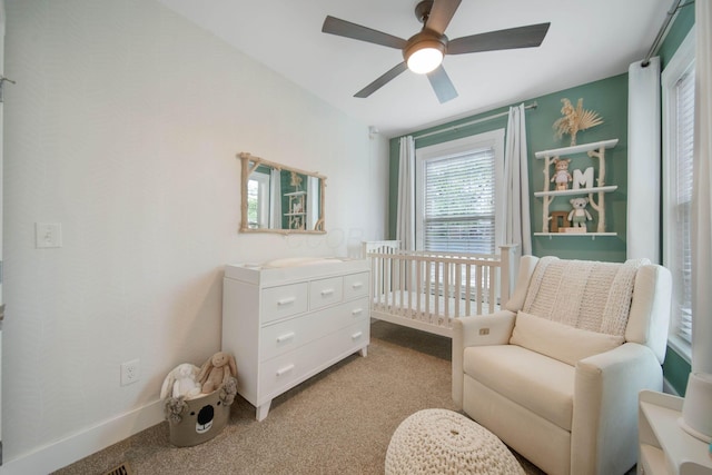 62 Sherman Ave, Columbus, OH 43205 - carpeted bedroom with ceiling fan, a crib, and baseboards