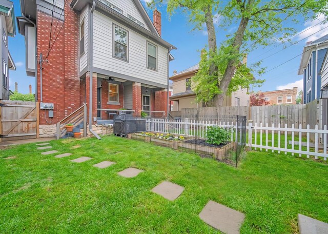 62 Sherman Ave, Columbus, OH 43205 - rear view of property featuring a garden, a chimney, and brick siding