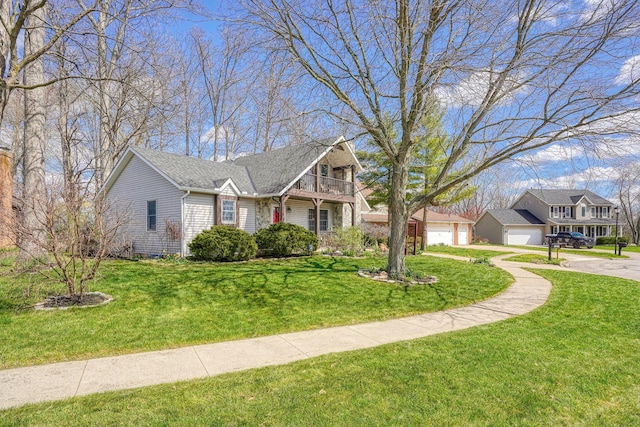 view of front of property with a front lawn, a garage, and a balcony