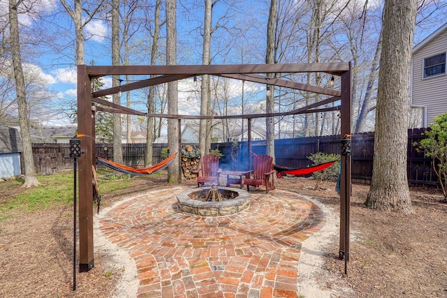 view of patio / terrace featuring an outdoor fire pit and a fenced backyard