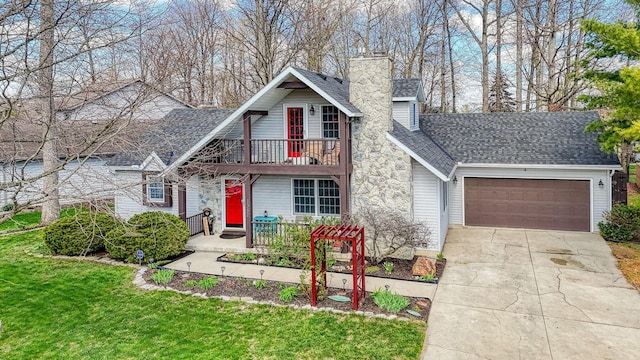 traditional home featuring a balcony, an attached garage, a chimney, a shingled roof, and concrete driveway