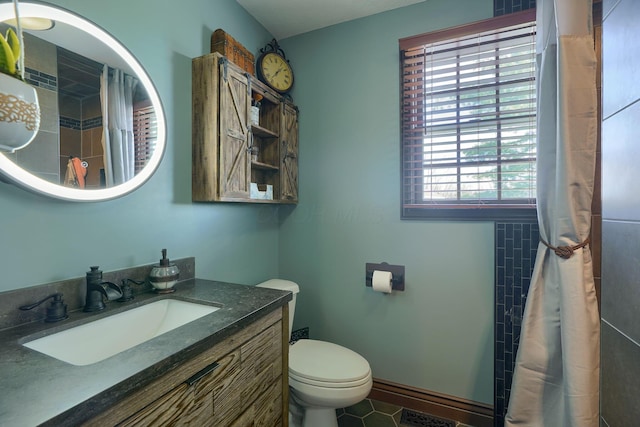 full bath featuring toilet, a shower with curtain, and vanity