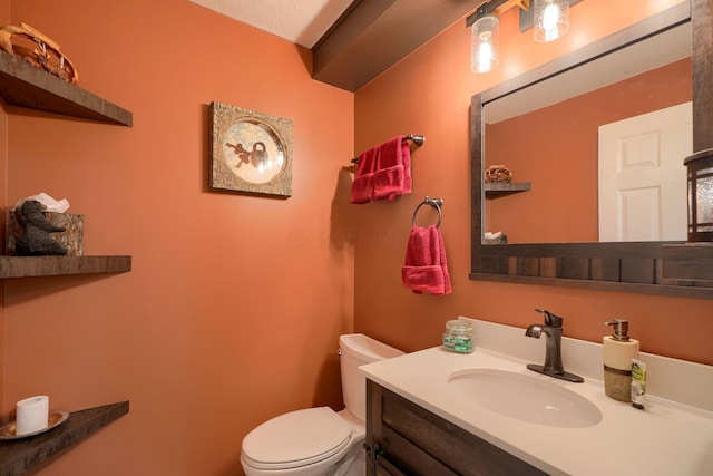 bathroom with toilet and vanity