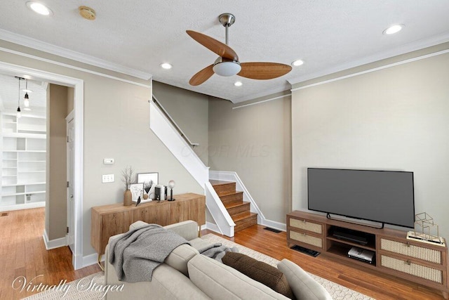 210 Warren St, Columbus, OH 43215 - living area with ceiling fan, stairway, wood finished floors, recessed lighting, and crown molding
