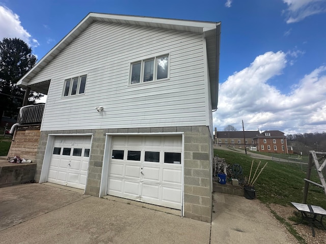113 Chestnut St SE, Corning, OH 43730 - view of home's exterior featuring concrete driveway and a garage