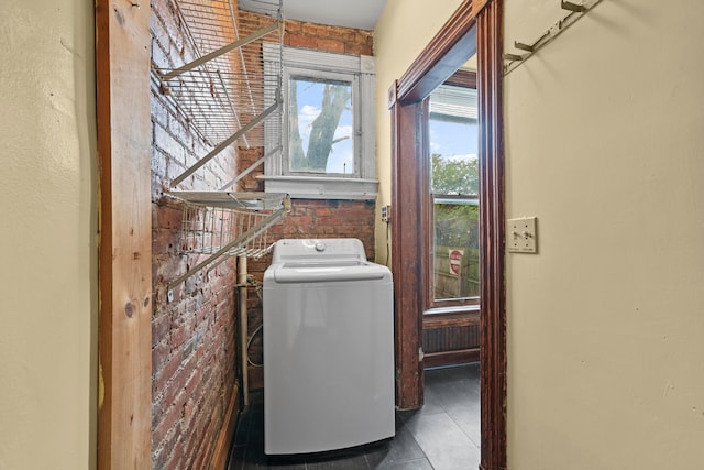 69-71 E 1st Ave, Columbus, OH 43201 - clothes washing area with brick wall, tile patterned floors, washer / dryer, and laundry area