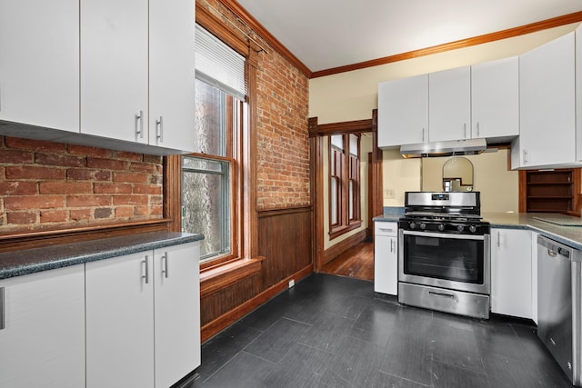 69-71 E 1st Ave, Columbus, OH 43201 - kitchen with crown molding, white cabinetry, under cabinet range hood, and stainless steel appliances