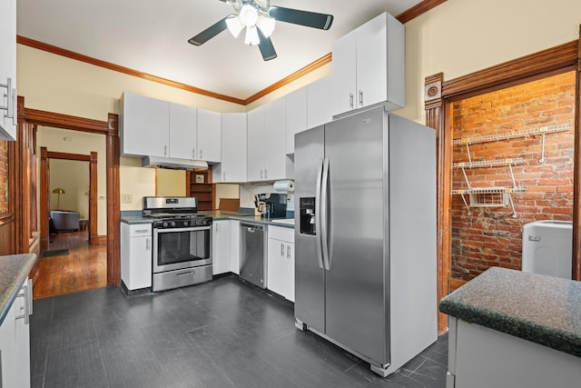 69-71 E 1st Ave, Columbus, OH 43201 - kitchen with washer / clothes dryer, white cabinets, ceiling fan, dark countertops, and stainless steel appliances