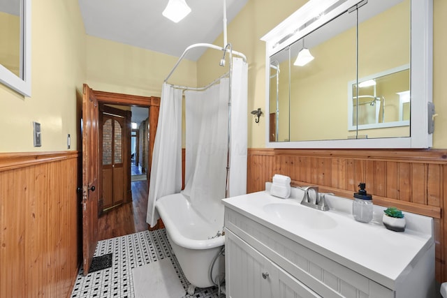 69-71 E 1st Ave, Columbus, OH 43201 - bathroom featuring wood walls, wainscoting, and a shower with curtain