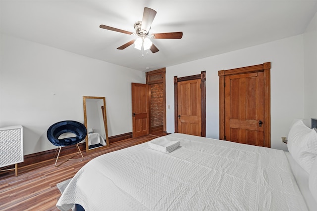 69-71 E 1st Ave, Columbus, OH 43201 - bedroom featuring wood finished floors, baseboards, and a ceiling fan