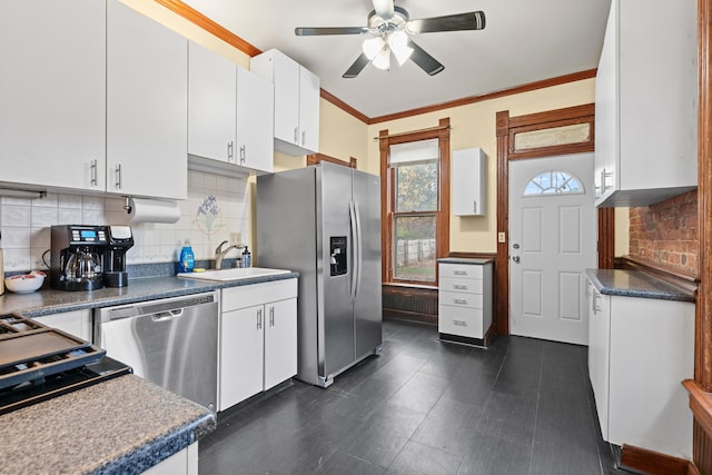 69-71 E 1st Ave, Columbus, OH 43201 - kitchen with ornamental molding, backsplash, a ceiling fan, appliances with stainless steel finishes, and a sink