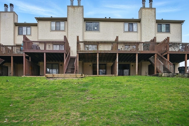 5696 Great Hall Ct, Columbus, OH 43231 - rear view of house featuring a yard, stucco siding, stairs, and a chimney