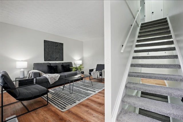 5696 Great Hall Ct, Columbus, OH 43231 - staircase with a textured ceiling, baseboards, and wood finished floors