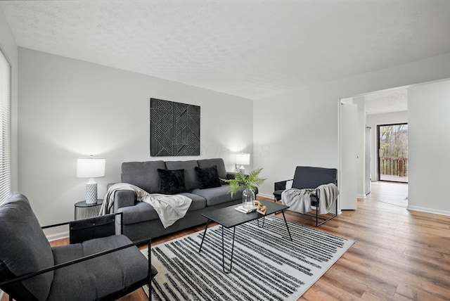 5696 Great Hall Ct, Columbus, OH 43231 - living room featuring baseboards, wood finished floors, and a textured ceiling