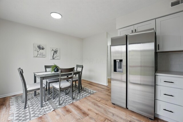 5696 Great Hall Ct, Columbus, OH 43231 - dining room with baseboards, visible vents, and light wood-style flooring