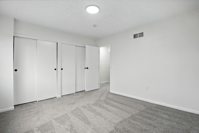 5696 Great Hall Ct, Columbus, OH 43231 - unfurnished bedroom with baseboards, visible vents, carpet, and two closets