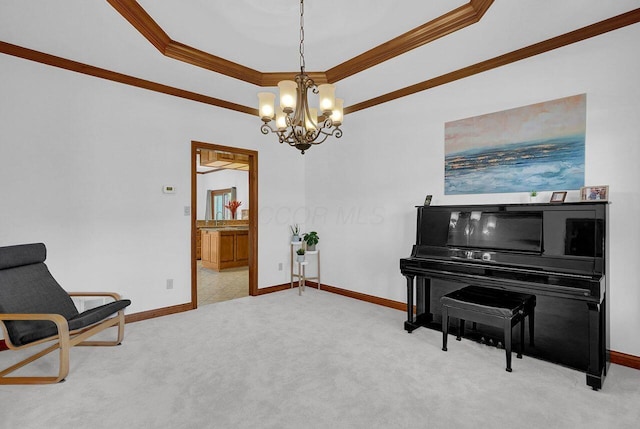 living area featuring ornamental molding, carpet, a chandelier, and a tray ceiling